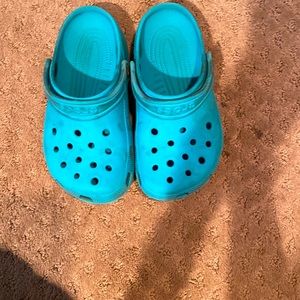 Teal crocs size 2 in kids.